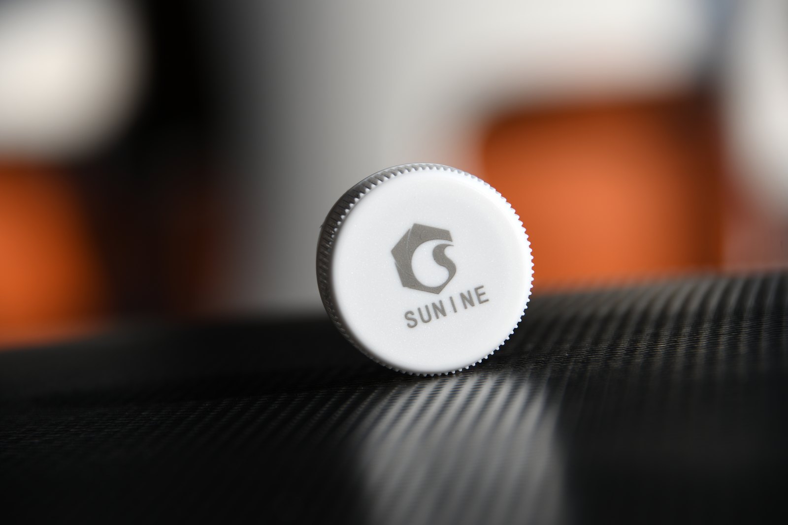 Permanent SUNINE logo laser marking on a beverage bottle cap